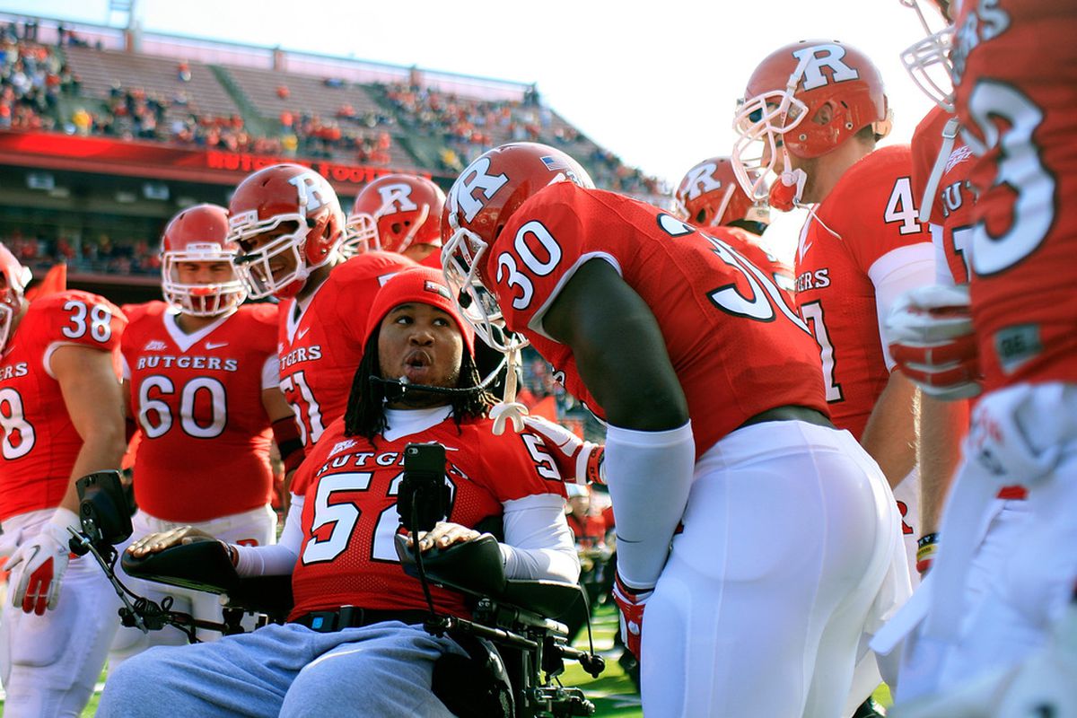 Eric LeGrand, 52, formerly of the Rutgers Scarlet Knights lead his teammates onto the field for the team's Senior Day celebration at Rutgers Stadium Nov. 19, 2011. LeGrand was paralyzed during a kickoff return in October 2010. 