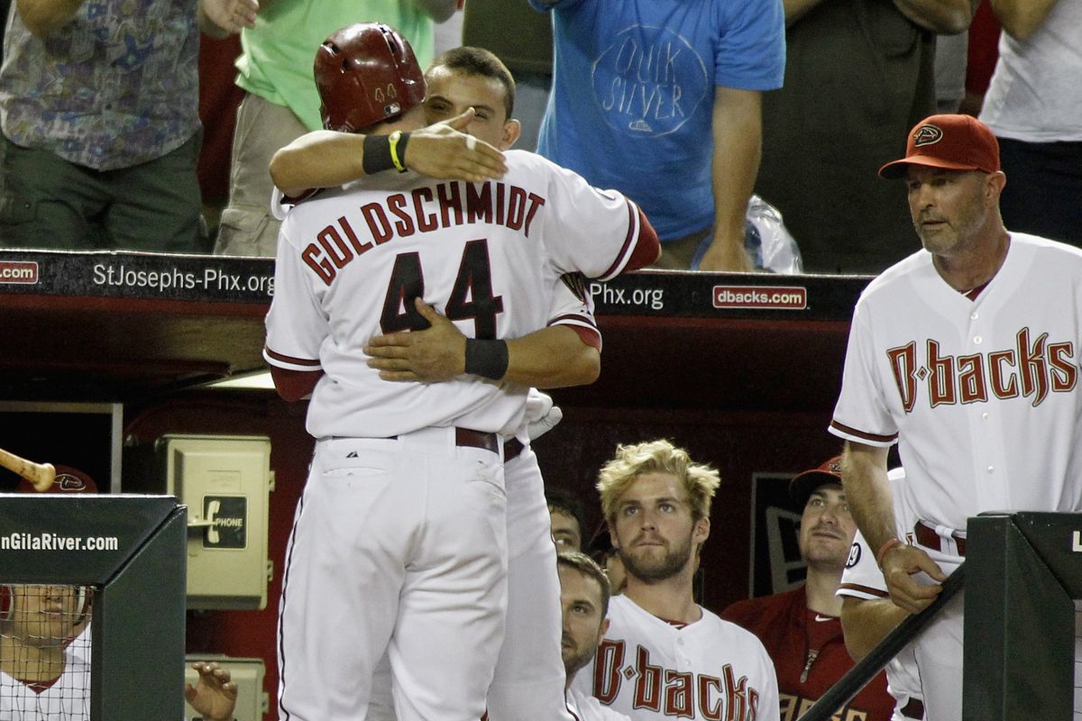 Huggers for sluggers: Parra embraces Goldschmidt after his ninth-inning homer tied the game on August 13