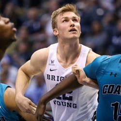 Brigham Young Cougars forward Eric Mika (12) and Coastal Carolina Chanticleers forward Amidou Bamba (15) compete for a rebound after free throws during a game at the Marriott Center in Provo on Saturday, Nov. 19, 2016.