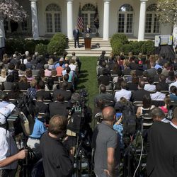 In this photo taken April 10, 2013, President Barack Obama, top center, accompanied acting Budget Director Jeffrey Zients speaks in the Rose Garden at the White House in Washington to discuss his proposed federal budget. Presidents like to take credit for economic recoveries, just as Obama is angling to do now. He and his allies in Congress have "walked the economy back from the brink," his new 2014 federal budget blueprint asserts. And Democrats hope these improvements, while still slow and uneven, will give them at least a small boost in 2014's midterm races.  