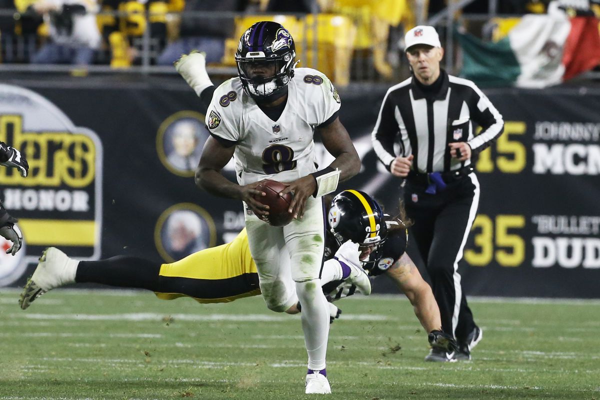 Baltimore Ravens quarterback Lamar Jackson (8) runs with the ball past Pittsburgh Steelers defensive end Henry Mondeaux (99) during the second quarter at Heinz Field. Pittsburgh won 20-19.