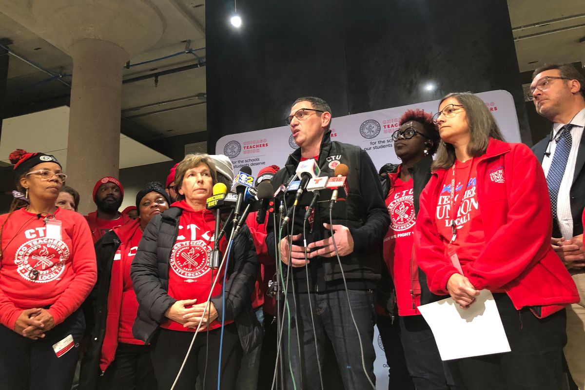 Chicago Teachers Union chief Jesse Sharkey, stands with union leaders after a House of Delegates vote to accept a tentative contract, Oct. 30, 2019.