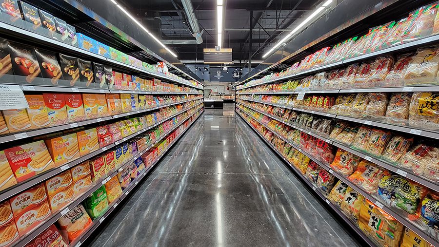 An aisle filled with colorful boxes of food products.
