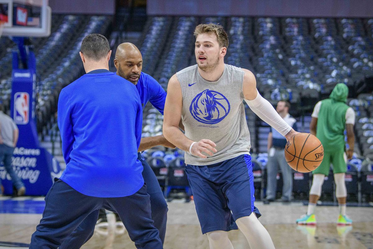 Dallas Mavericks forward Luka Doncic works out with trainers before the game between the Mavericks and the Boston Celtics at the American Airlines Center.&nbsp;