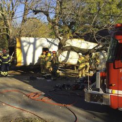 In this photo provided by the Chattanooga Fire Department via Chattanooga Times Free Press, Chattanooga Fire Department members work the scene of a fatal elementary school bus crash in Chattanooga, Tenn., Monday, Nov. 21, 2016. In a news conference Monday, Assistant Chief Tracy Arnold said there were multiple fatalities in the crash. 