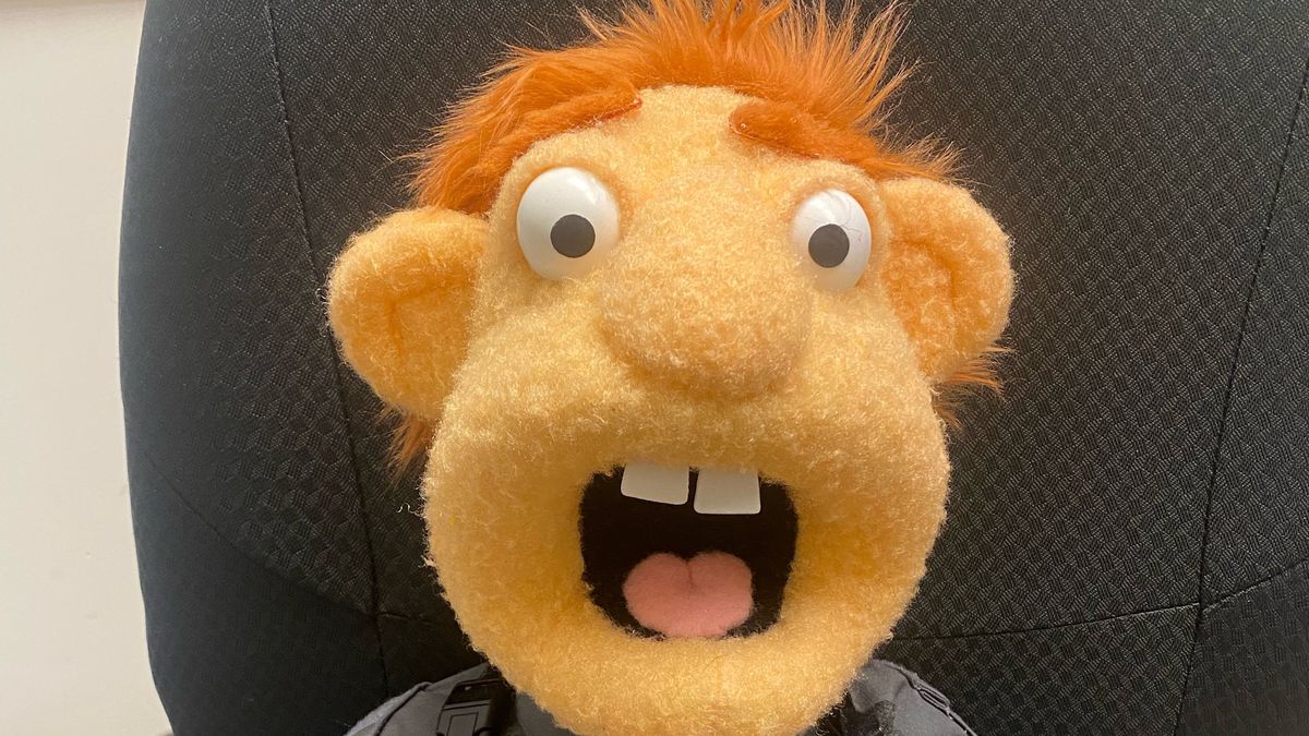 A behind the scenes close-up of a puppet with a shocked expression on his orange face from the Prime Video series Gen V