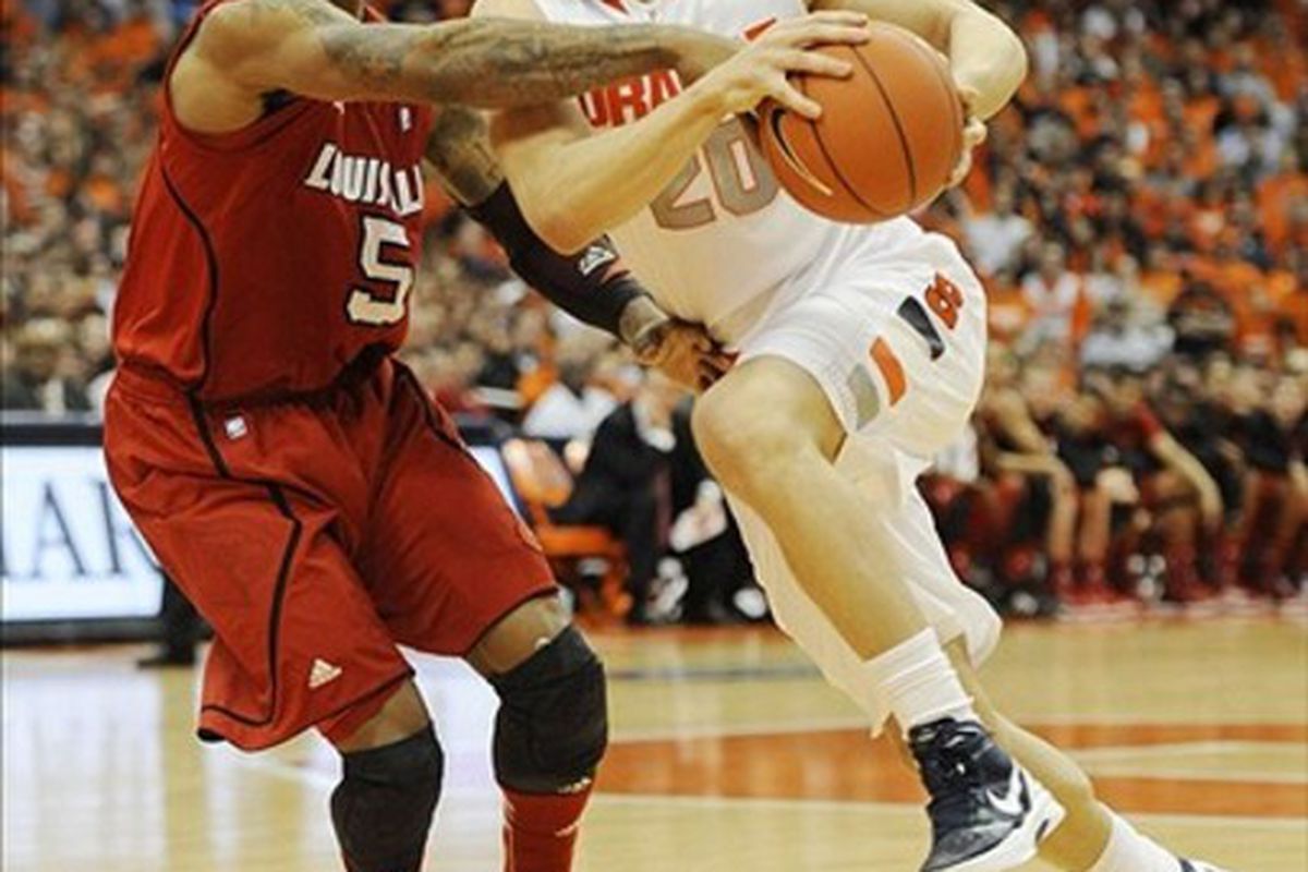 Mar 3, 2012; Syracuse, NY, USA; Syracuse Orange guard Brandon Triche (20) drives against Louisville Cardinals guard Chris Smith (5) during the game at the Carrier Dome.  Richard Mackson-US PRESSWIRE