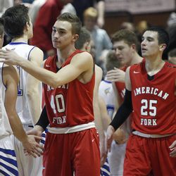 The American Fork Cavemen shake hands with the Pleasant Grove Vikings after their boys basketball in Pleasant Grove Tuesday, Feb. 3, 2015.