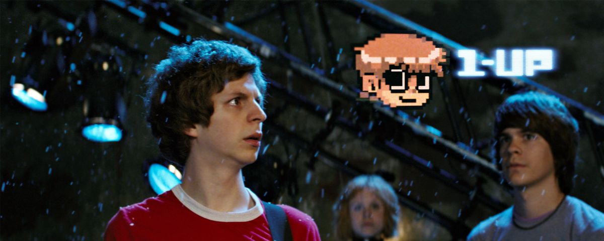 michael cera in scott pilgrim vs. the world looking up at a 1-up head in the air in front of him