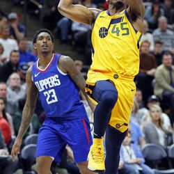 Utah Jazz guard Donovan Mitchell drives to the basket with LA Clippers guard Lou Williams at left during NBA basketball in Salt Lake City on Saturday, Jan. 20, 2018.