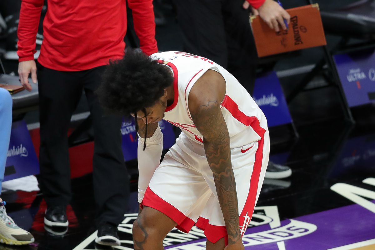 Houston Rockets guard Kevin Porter Jr. holds his left knee during the second quarter against the Sacramento Kings at Golden 1 Center.&nbsp;