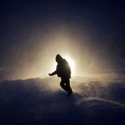 In this Tuesday, Nov. 29, 2016, photo, a person walks through a snow storm at the Oceti Sakowin camp where people have gathered to protest the Dakota Access oil pipeline in Cannon Ball, N.D. Those in the camp have shrugged off the heavy snow, icy winds and frigid temperatures. But if they defy next week's government deadline to abandon the camp, demonstrators know the real deep freeze lies ahead. 