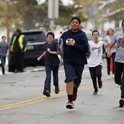 Some students run to meet their parents following a shooting incident at Mueller Park Junior High School in Bountiful on Thursday, Dec. 1, 2016.