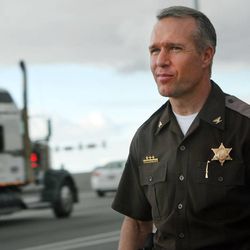 Col. Dan Fuhr of the Utah Highway Patrol returns to his vehicle after issuing a warning Tuesday, Feb. 10, 2015, to a driver who was texting while driving on I-15 in South Salt Lake City.