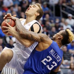 Brigham Young Cougars guard Chase Fischer (1) is fouled by Creighton Bluejays guard James Milliken (23) as BYU and Creighton play in NIT quarterfinal action at the Marriott Center in Provo Tuesday, March 22, 2016.