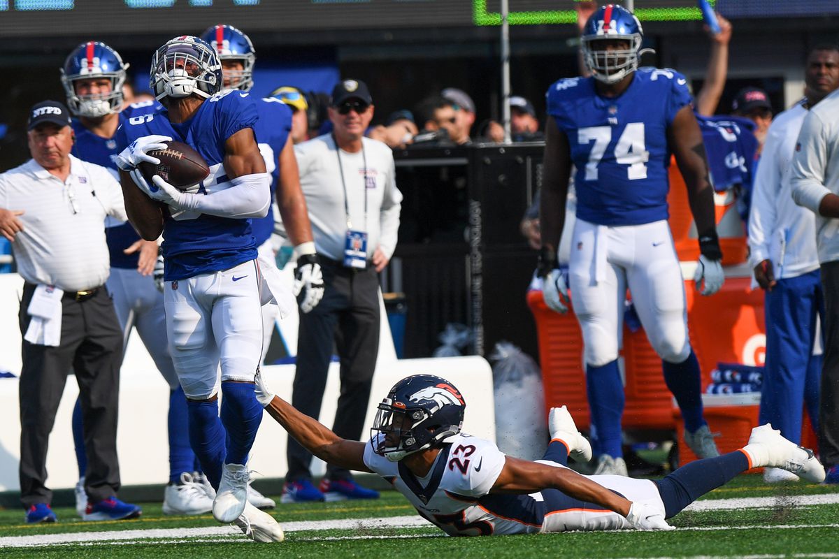New York Giants wide receiver Darius Slayton (86) makes a catch defended by Denver Broncos cornerback Kyle Fuller (23) during the first half at MetLife Stadium.