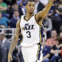 Utah Jazz guard Trey Burke points down court in the second half during an NBA basketball game against the Minnesota Timberwolves, Tuesday, Dec. 30, 2014, in Salt Lake City. The Jazz won 100-94.