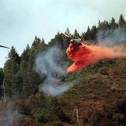 Aircraft assist in fighting the Salt Creek Fire in Shasta County, Calif., Thursday, Aug. 2, 2012. More than 300 firefighters are battling a wildfire that threatens about 100 homes and other structures in the Shasta-Trinity National Forest in Northern California. 