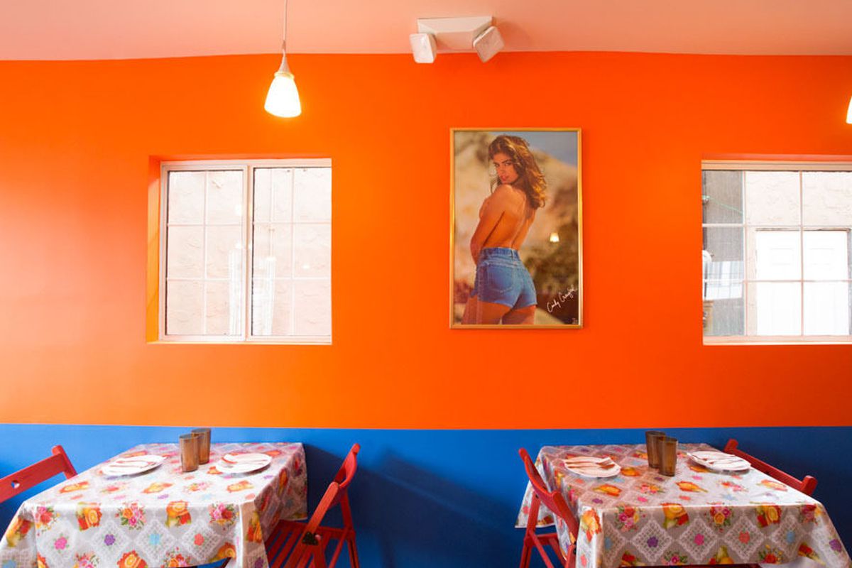 An orange restaurant interior of a thai restuarant.