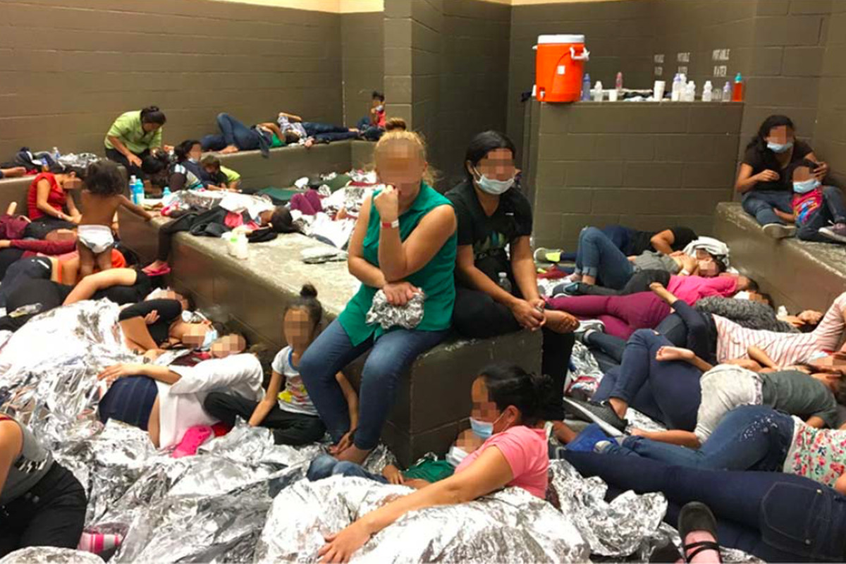 Government monitors photographed families detained in an overcrowded cell at a Border Patrol facility in Weslaco, Texas, on June 11, 2019.