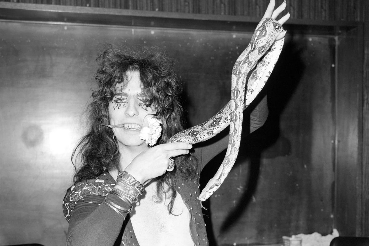 Pop singer Alice Cooper aged 23 flew into Heathrow Airport today with his pet boa constrictor, wearing a flimsy see-thro