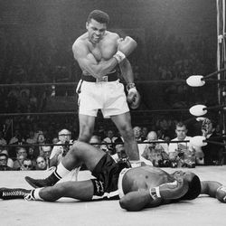 FILE - In this May 25, 1965, file photo, heavyweight champion Muhammad Ali, then known as Cassius Clay, stands over challenger Sonny Liston, shouting and gesturing shortly after dropping Liston with a short hard right to the jaw, in Lewiston, Maine. Ali's body will ride in a miles-long procession spanning his life — from his boyhood home where he shadowboxed and dreamed of greatness to the boulevard that bears his name and the museum that stands as a lasting tribute to his boxing triumphs and his humanitarian causes outside the ring. Ali died last Friday at 74 after a long battle with Parkinson's disease. 