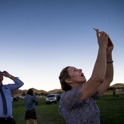 Rosey Dorney, of Brisbane, Australia, takes a photo during the total solar eclipse at Mann Creek Reservoir near Weiser, Idaho, on Monday, Aug. 21, 2017.