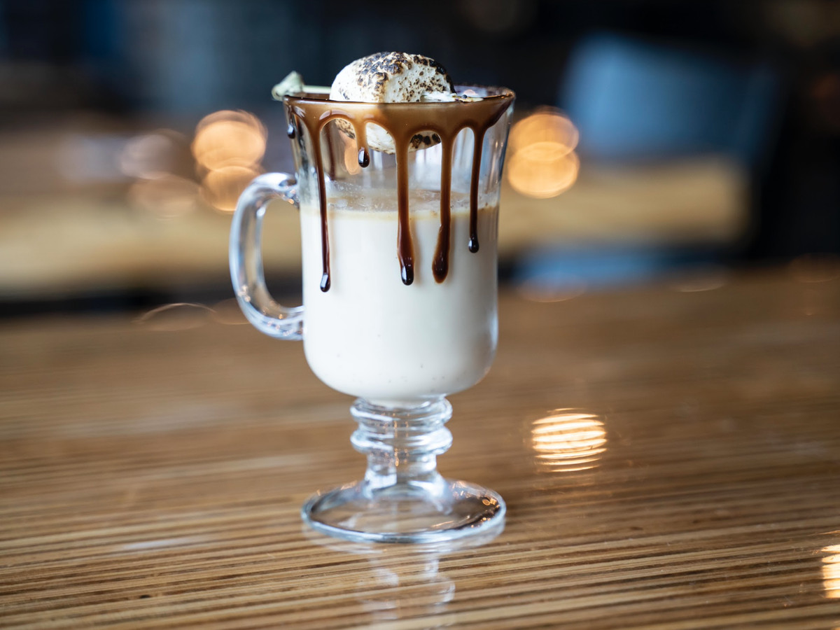 A cocktail in a glass mug with dripping chocolate.