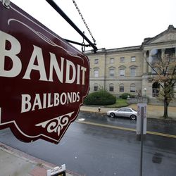 This Oct. 23, 2014 file photo a sign is seen outside a bail bondsman across the street from Mercer County criminal courthouse in Trenton, N.J. (AP Photo/Mel Evans,File)