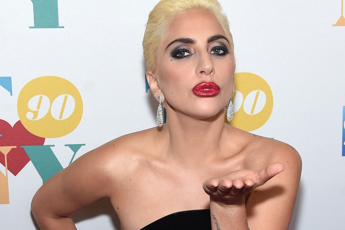 Lady Gaga blowing a kiss on the red carpet at Tony Bennett's 90th birthday party.