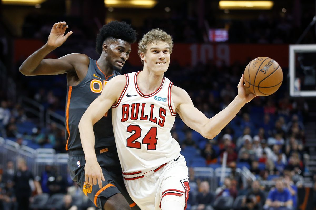 Chicago Bulls forward Lauri Markkanen passes the ball in front of Orlando Magic forward Jonathan Isaac during the first quarter at Amway Center.