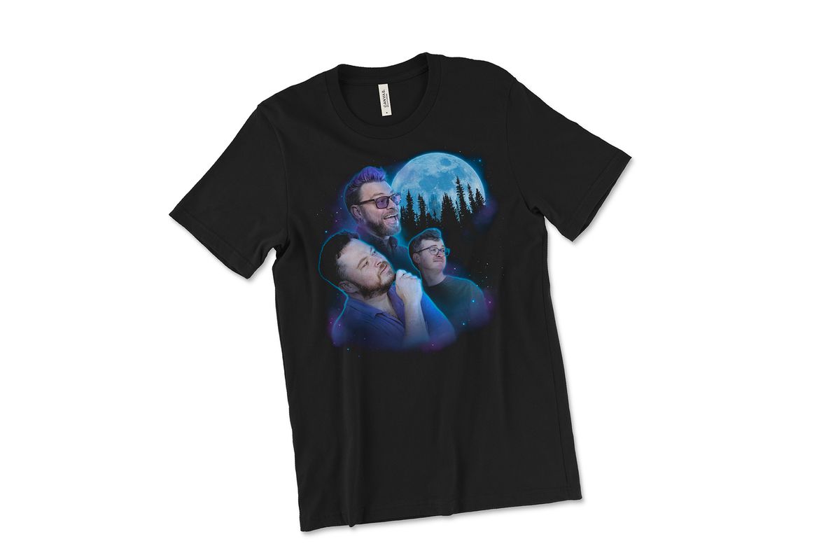 A black t-shirt with a graphic of the McElroy brothers in the center. The three brothers are gazing longingly at a full moon. There is a shadowed range of trees in front of the moon and a smattering of stars around the edges of the image. In the image of the McElroys, Justin is in the foreground, Griffin is in the mid-ground, and Travis is in the background. 