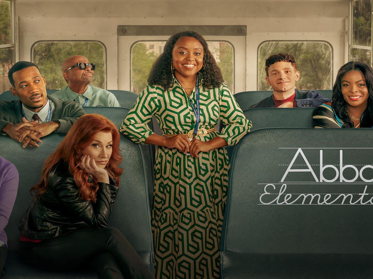 The seven main cast members of Abbott Elementary posed on a school bus.