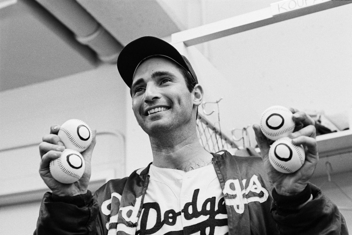 Sandy Koufax Holding 4 “Zero” Baseballs