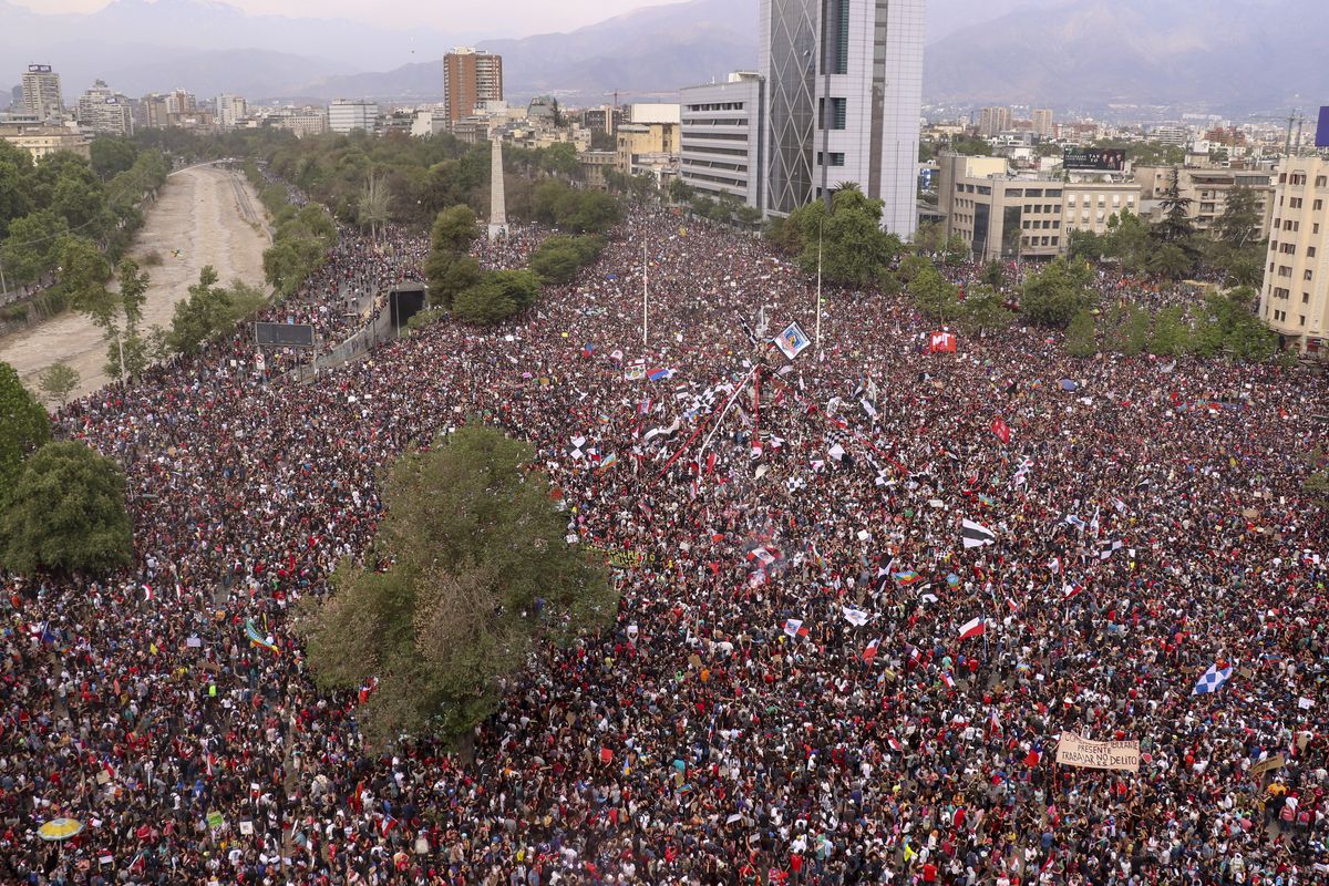 Thousands of demonstrators fill a public plaza in Santiago, Chile.