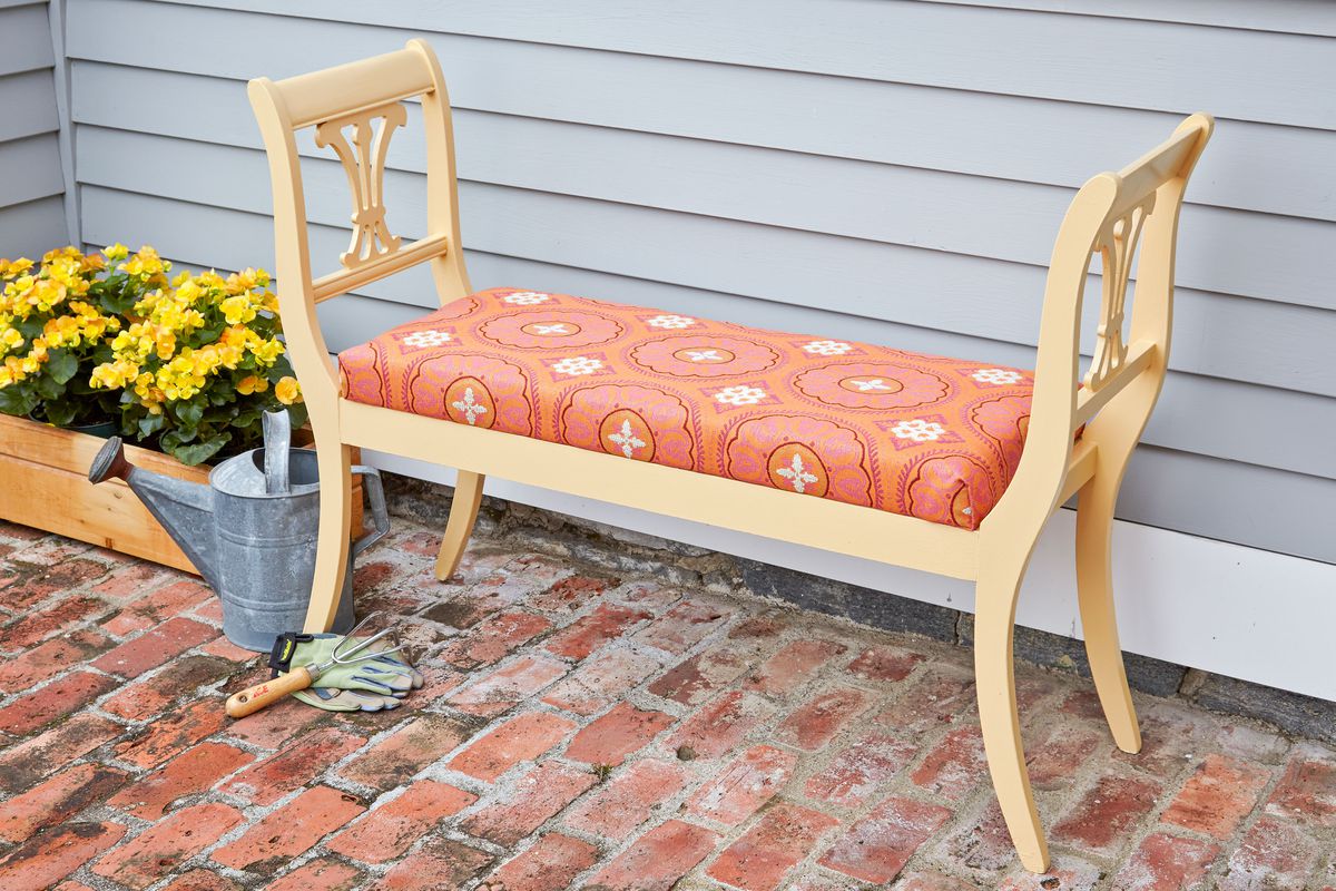 An outdoor bench made from dining chairs.