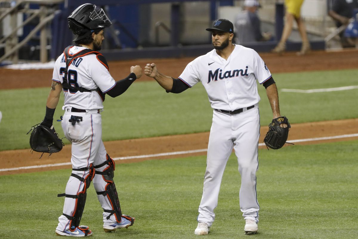 Miami Marlins relief pitcher Yimi Garcia (93) celebrates with catcher Jorge Alfaro (38) after winning the game against the Philadelphia Phillies at loanDepot Park.&nbsp;