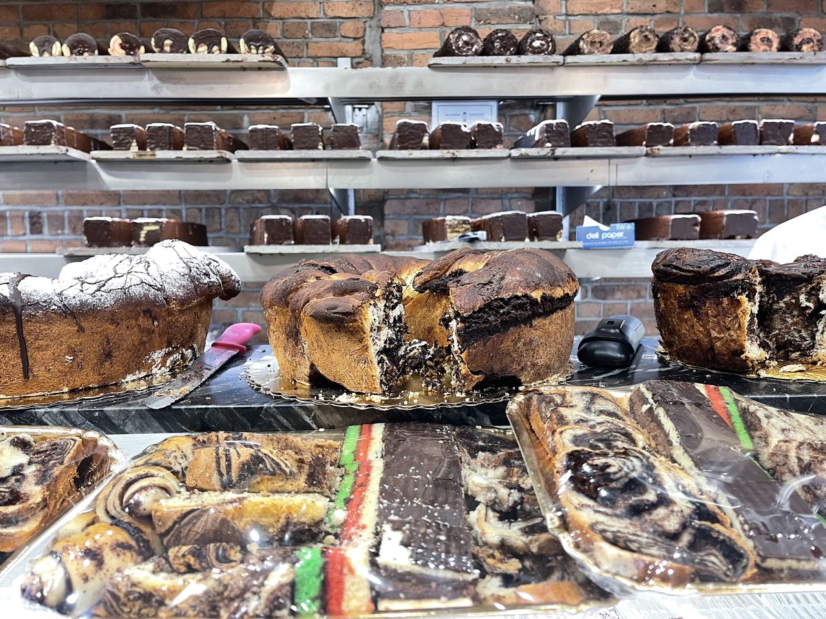 A pastry case loaded with cakes, cookies, and other baked goods inside the Sander’s shop. 