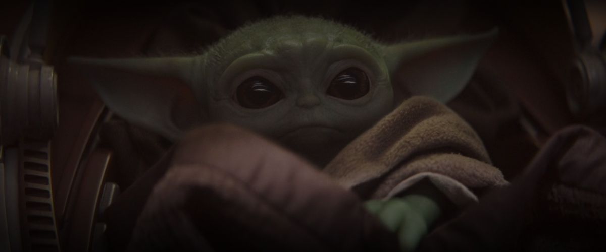 A little baby from Yoda’s species lays in a space crib in The Mandalorian