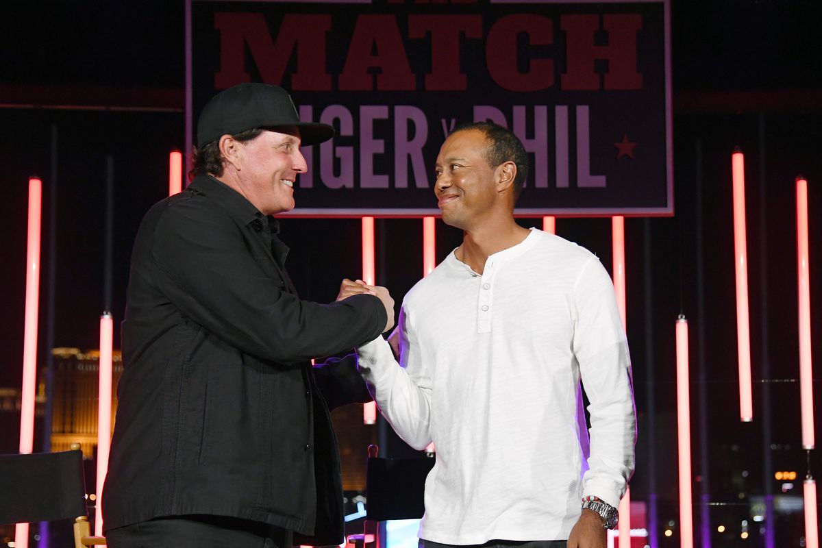 Phil Mickelson and Tiger Woods greet each other at The Match: Tiger vs Phil VIP after party at Topgolf Las Vegas on November 23, 2018 in Las Vegas, Nevada.