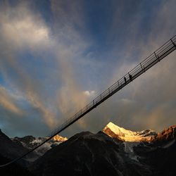 A couple walks on the "Europabruecke", supposed to be the world's longest pedestrian suspension bridge with a length of 494m, prior to the official inauguration of the construction in Randa, Switzerland, on Saturday, July 29, 2017. The bridge is situated on the Europaweg that connects the villages of Zermatt and Graechen.
