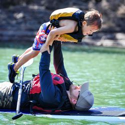 Heath Hinton and his son Kaleb enjoy a stand-up paddle board during the Continue Mission veterans event at Tibble Fork in American Fork Canyon on Aug. 17, 2017.