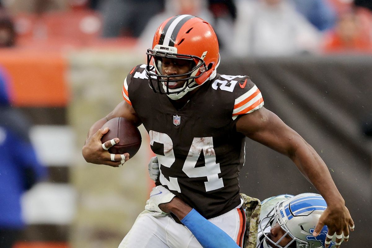 Nick Chubb #24 of the Cleveland Browns runs with the ball Tracy Walker III #21 of the Detroit Lions in the third quarter at FirstEnergy Stadium on November 21, 2021 in Cleveland, Ohio.