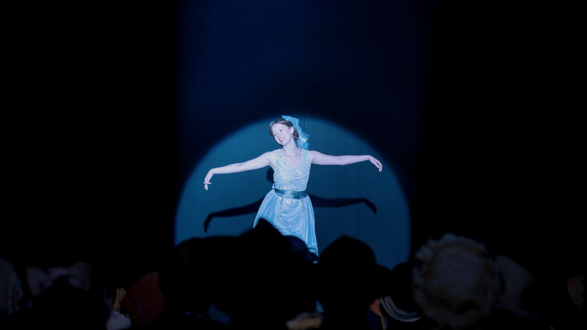Mia Goth dances in a blue spotlight onstage in Ti West’s Pearl