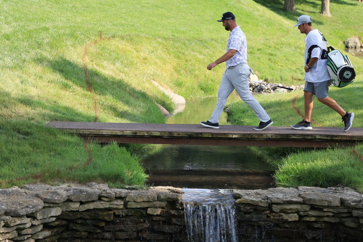 Jon Rahm of Spain and his caddie, Adam Hayes, walk to the 17th green during the third round of The Memorial Tournament at Muirfield Village Golf Club on June 05, 2021 in Dublin, Ohio.