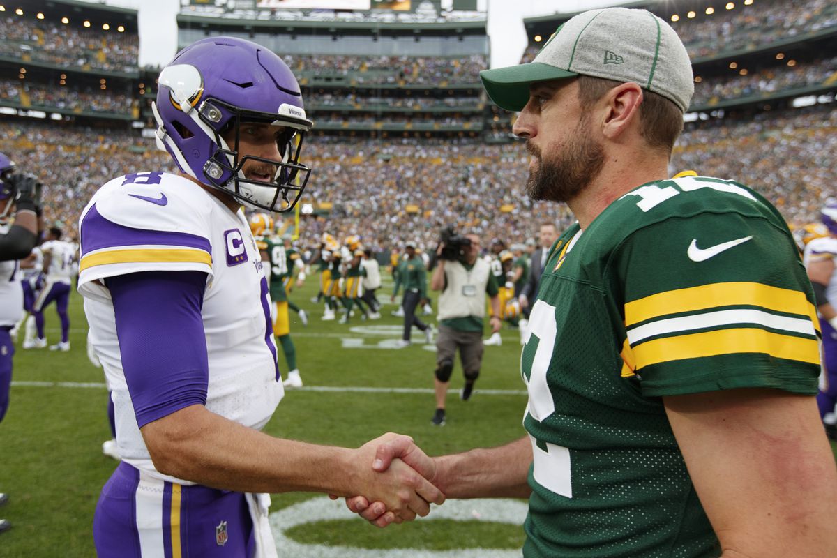 Minnesota Vikings quarterback Kirk Cousins greets Green Bay Packers quarterback Aaron Rodgers on the field following the game at Lambeau Field.