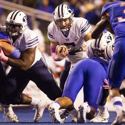 Brigham Young quarterback Taysom Hill (7) sneaks through the line for a first down during the first half of an NCAA football game between Boise State and Brigham Young in Boise on Thursday, Oct. 20, 2016.