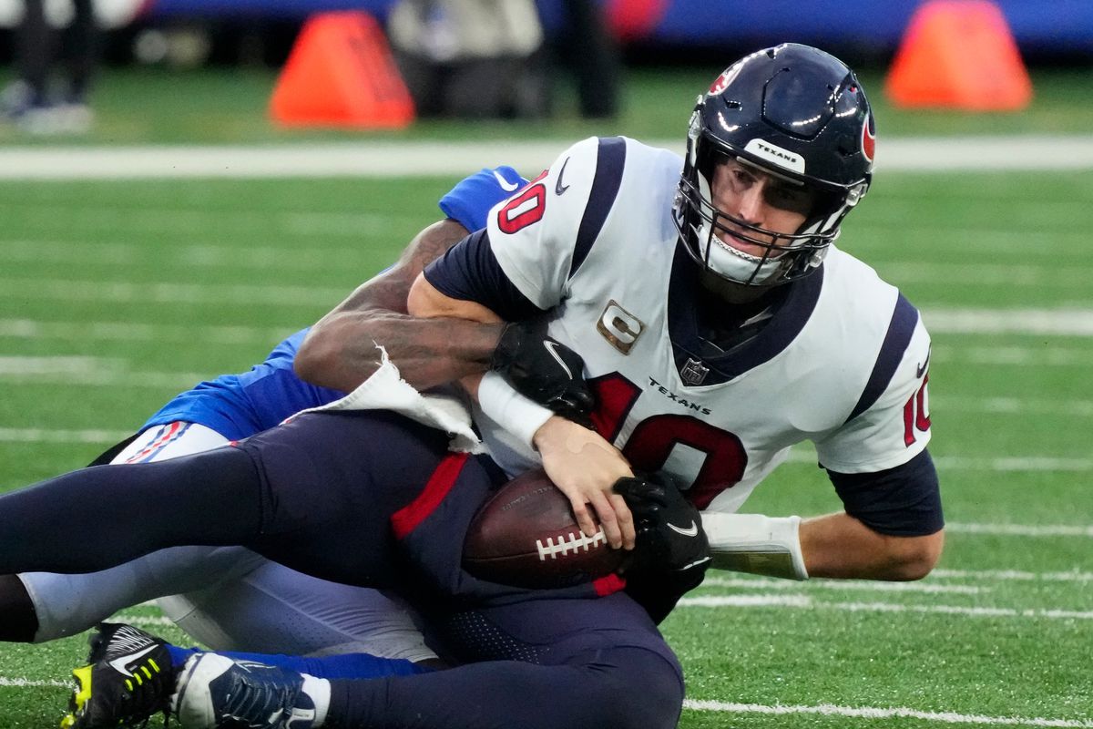 New York Giants cornerback Jason Pinnock (27) sacks Houston Texans quarterback Davis Mills (10) during the fourth quarter of a game at MetLife Stadium.