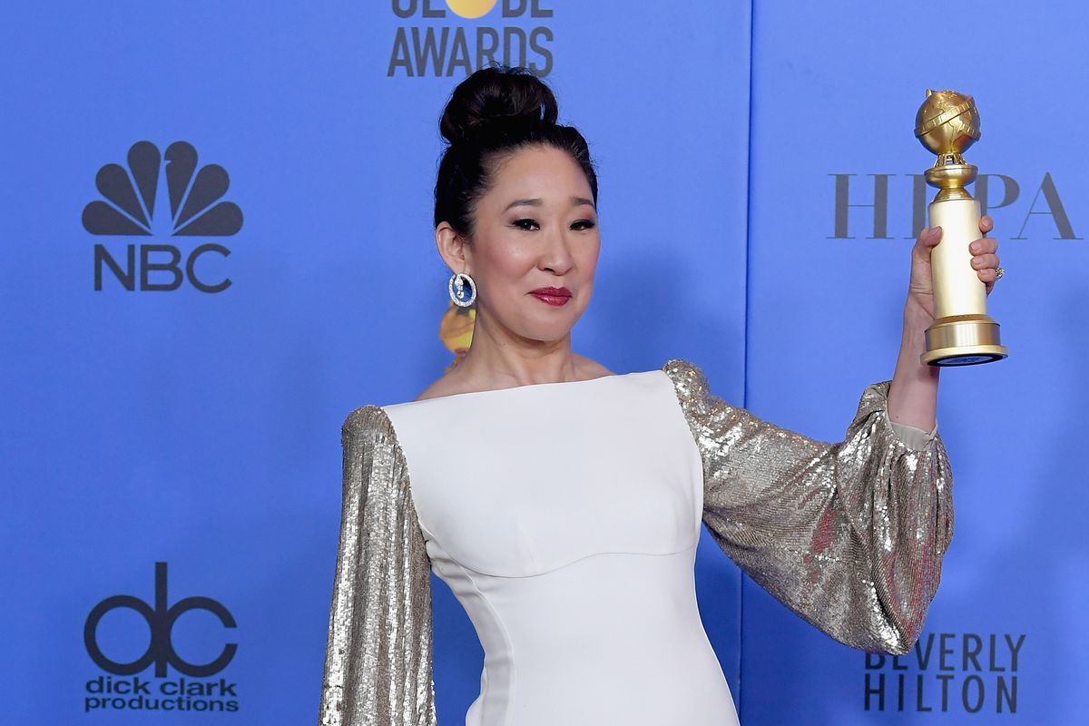Actress Sandra Oh holds up her statuette for best actress after the 2019 Golden Globes.