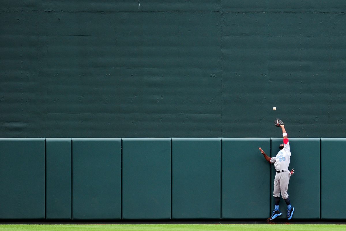 Fowler attempts to catch Trumbo's home run, but ends up running into the wall. A metaphor for the whole game, really.
